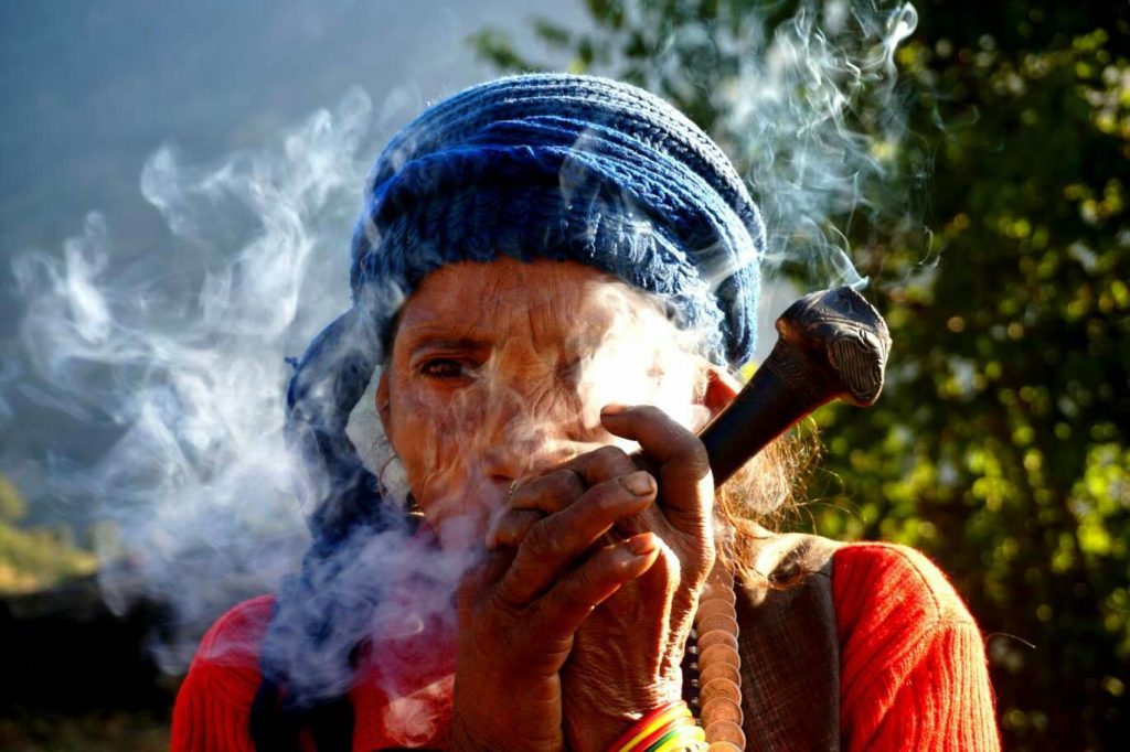 A Nepali lady & her wooden pipe.