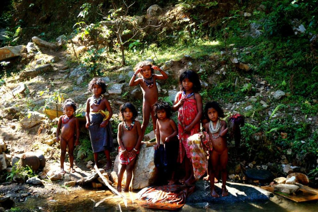 Children of Raute tribe bathing & playing by a stream