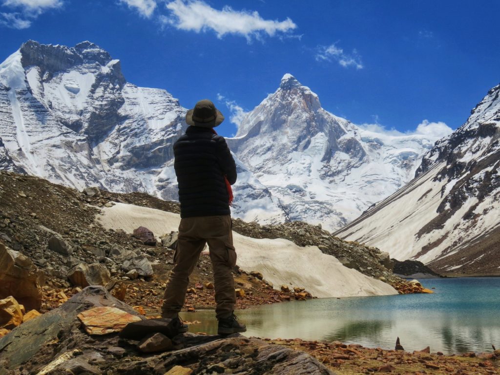 A trekker watching Thalayasagar peak from Kedartal lake shore
