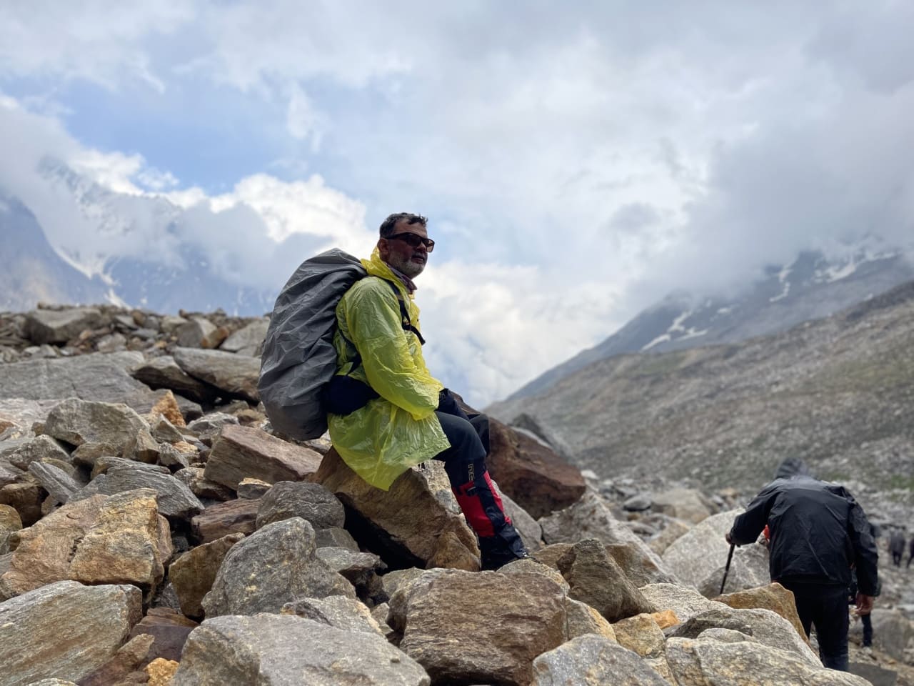 A trekker resting after crossing Khatling glacier