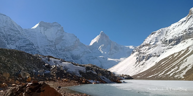Sunlit peaks of Mt Thalaysagar and Mt Bhrigupanth above frozen Kedartal Lake