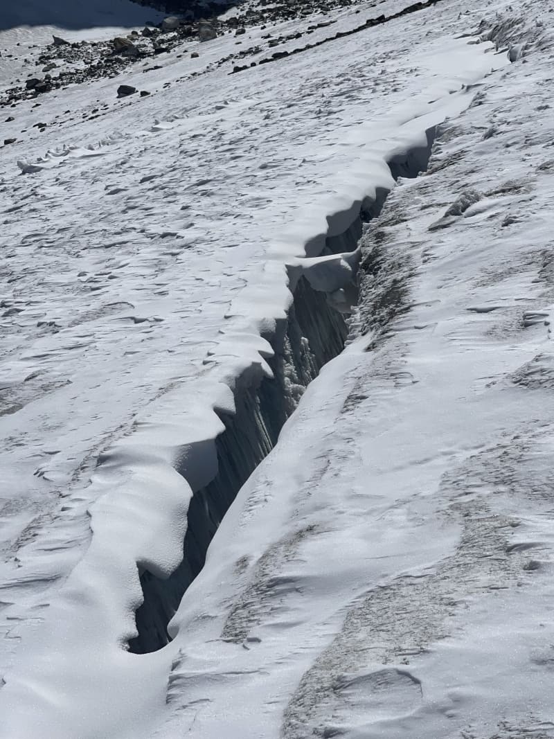A deep narrow crevasse in Khatling glacier