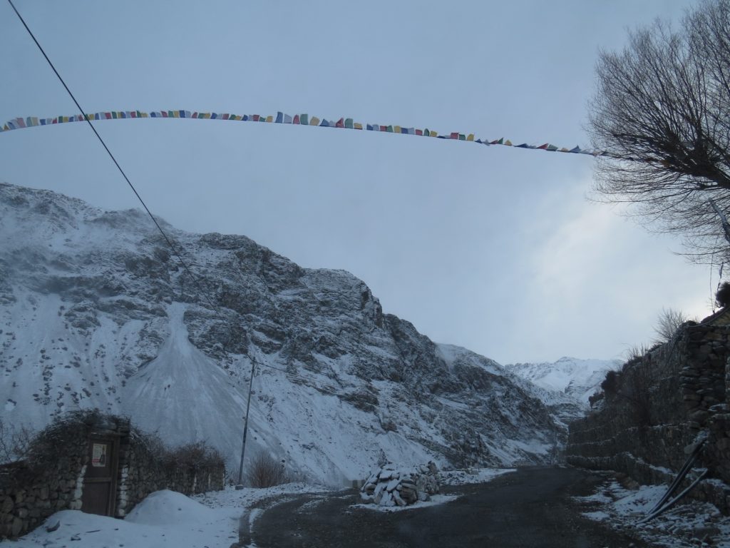 Buddhist prayer flag fluttering in snowy winds of Spiti