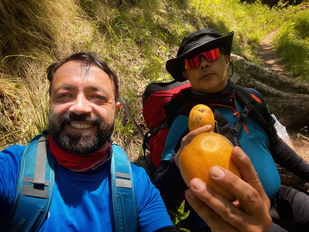 Trekkers taking selfie with mango