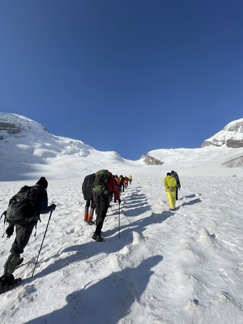 A group of trekkers climbing glacier below Auden's Col